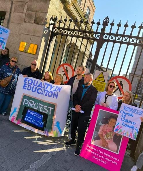 Councillor Conor Reddy and parents affected by the Special Needs Education school places crisis sntand at the gates of the Department of Education asking for Norma Foley to address the crisis. Their banner reads EQUALITY IN EDUCATION
