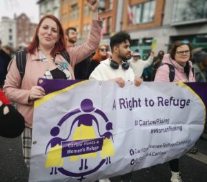 Campaigners marching behind a banner saying A Right To Refuge. Features People Before Profit's Carlow Councillor Adrienne Wallace.