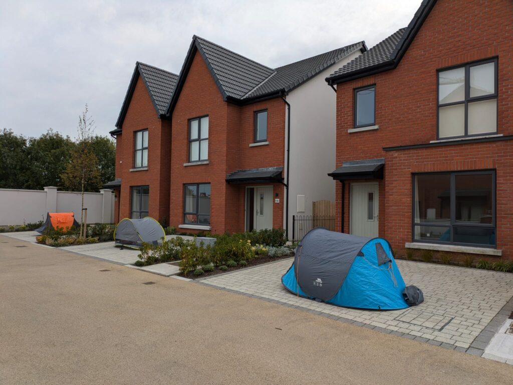 Tents pitched in front of the unoccupied houses Ryanair bought in Swords. These houses remain empty.
